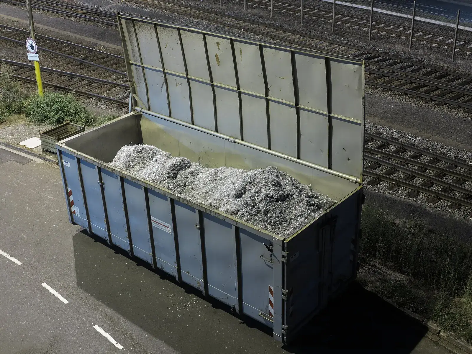Open container filled with aluminium swarf (turnings) at a manufacturing plant
