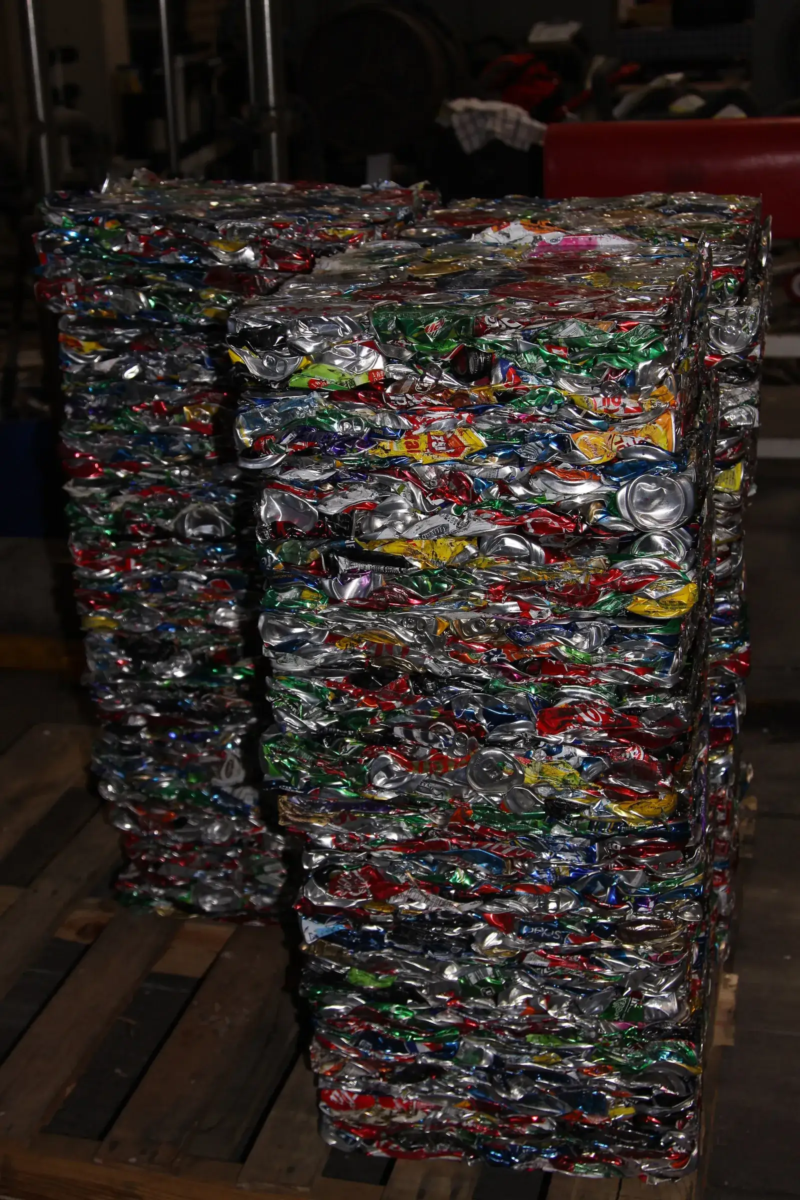 Blocks of crushed aluminium cans stacked at a recycling centre