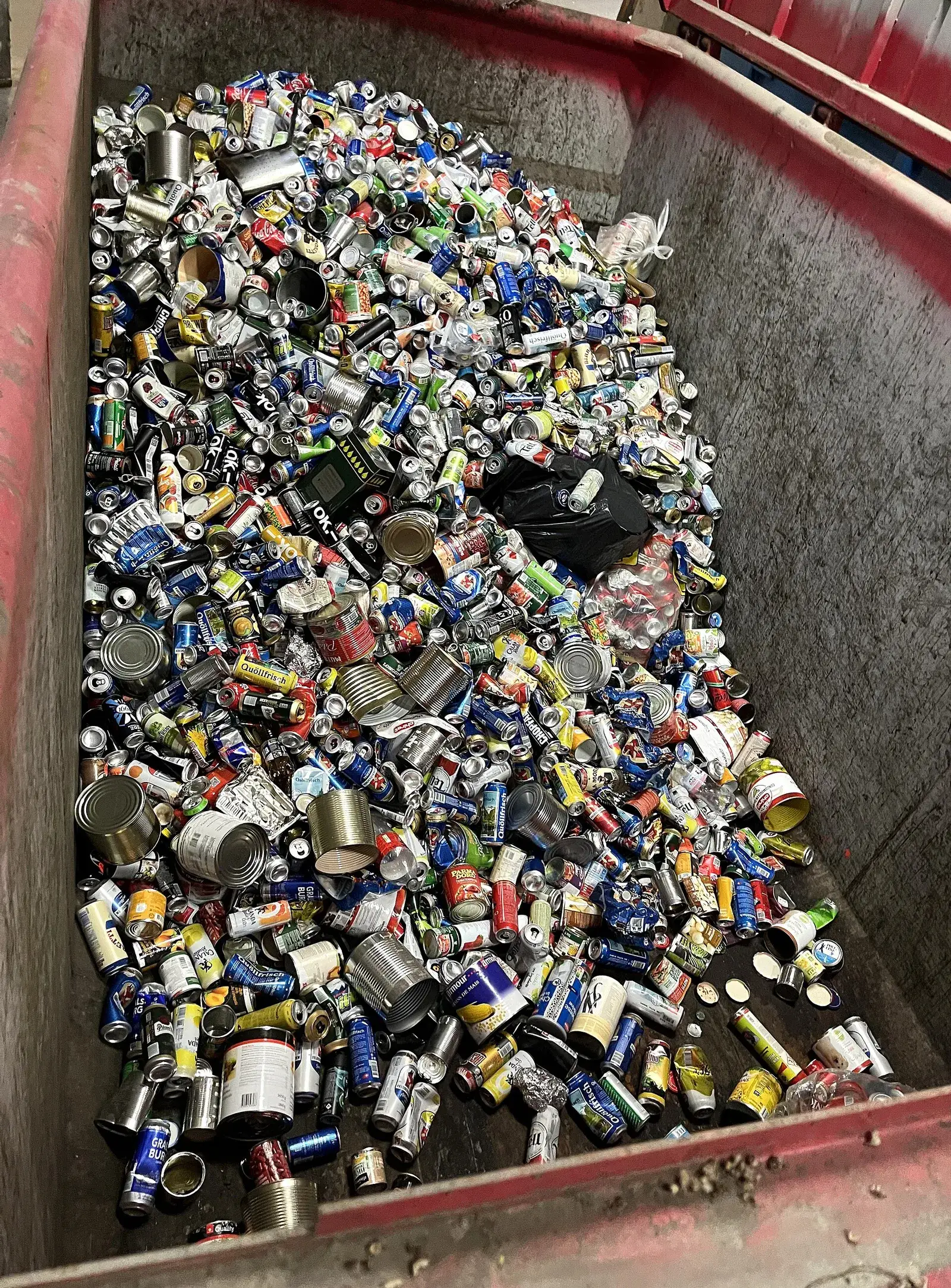 Bin of used aluminium beverage cans collected for recycling