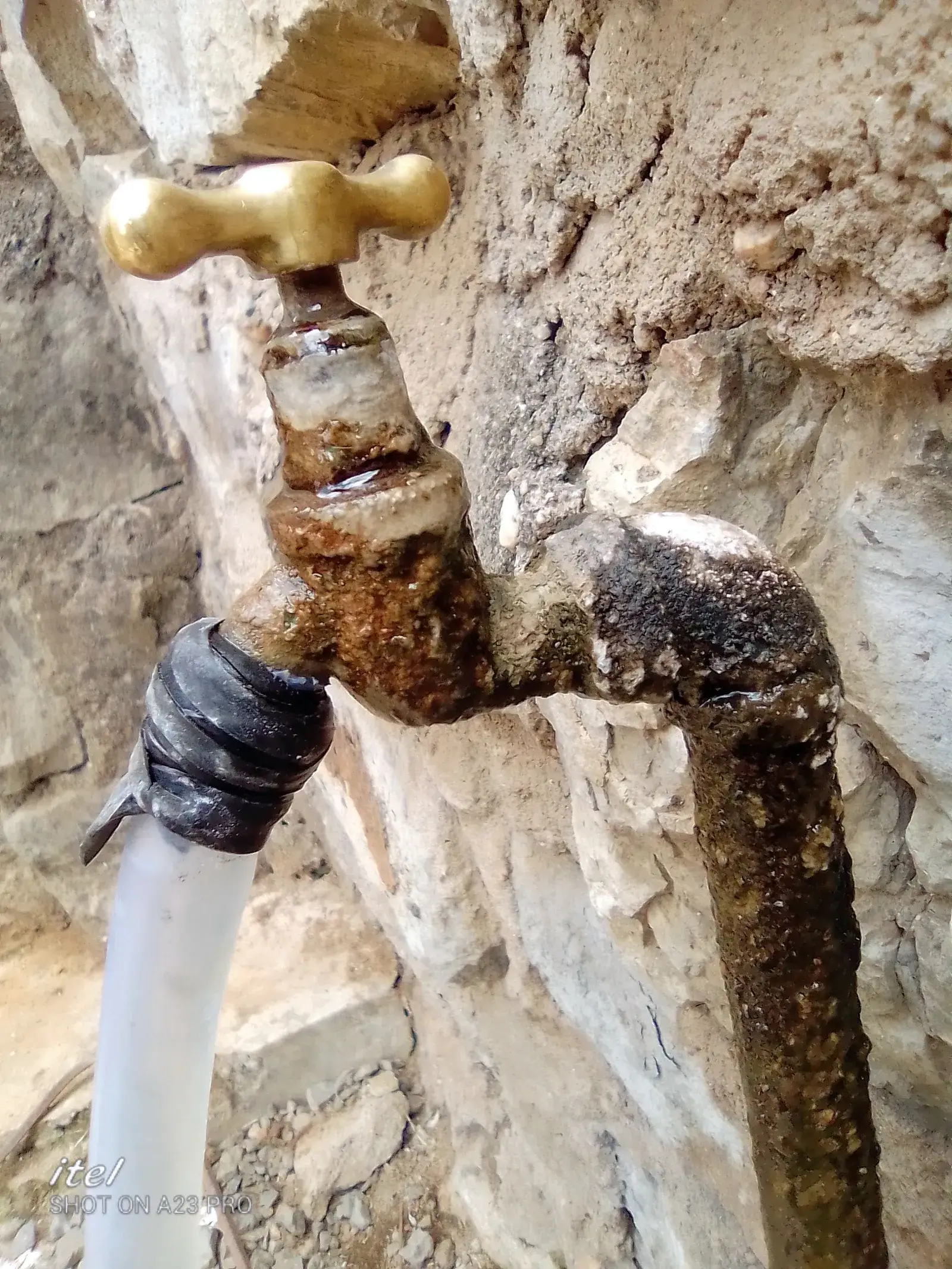 Corroded brass tap and pipe