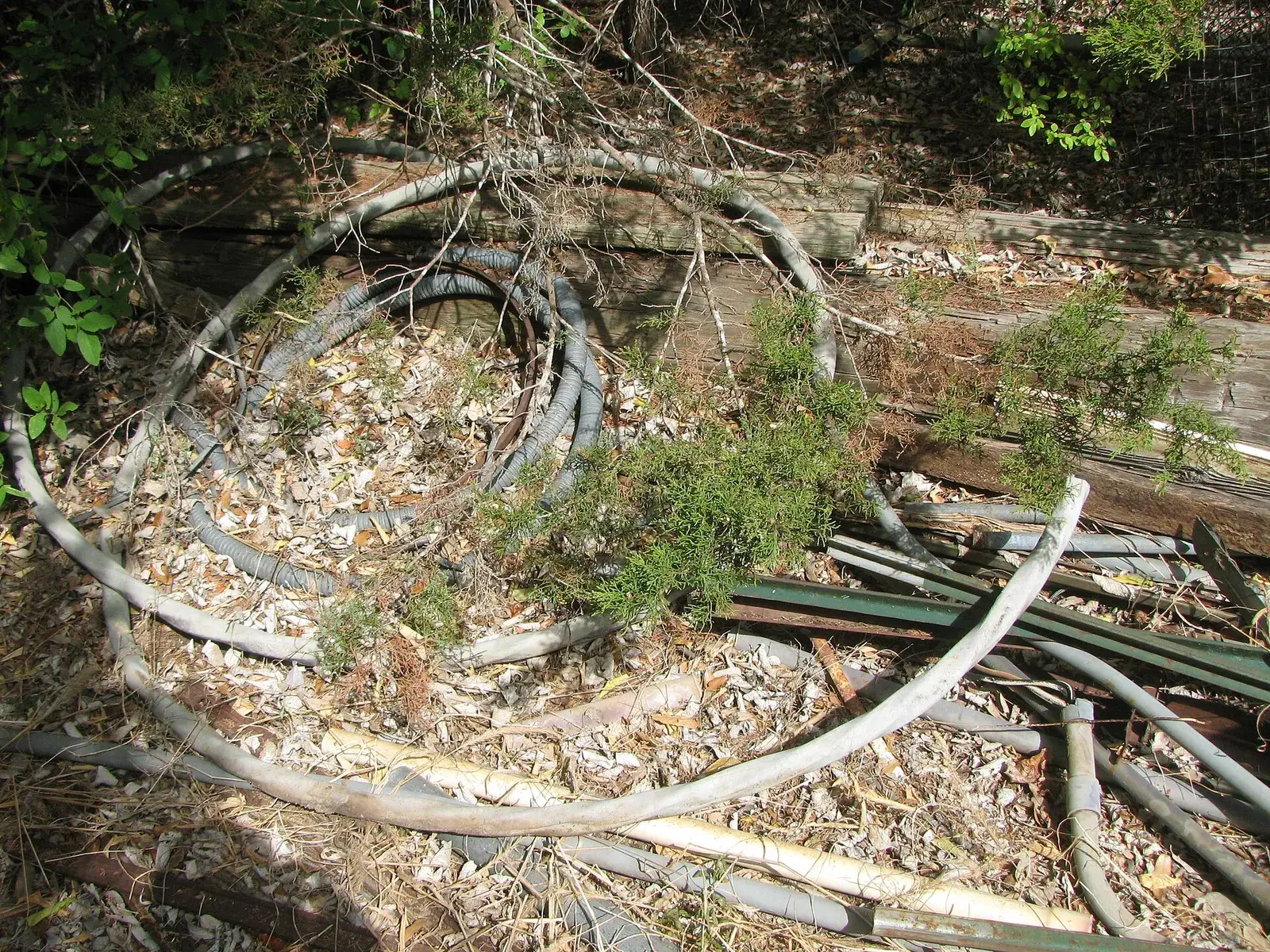 Pile of discarded electrical cables outdoors
