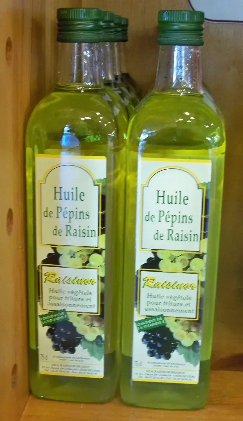 Two one-litre bottles of grapeseed oil with grape illustrations on the label