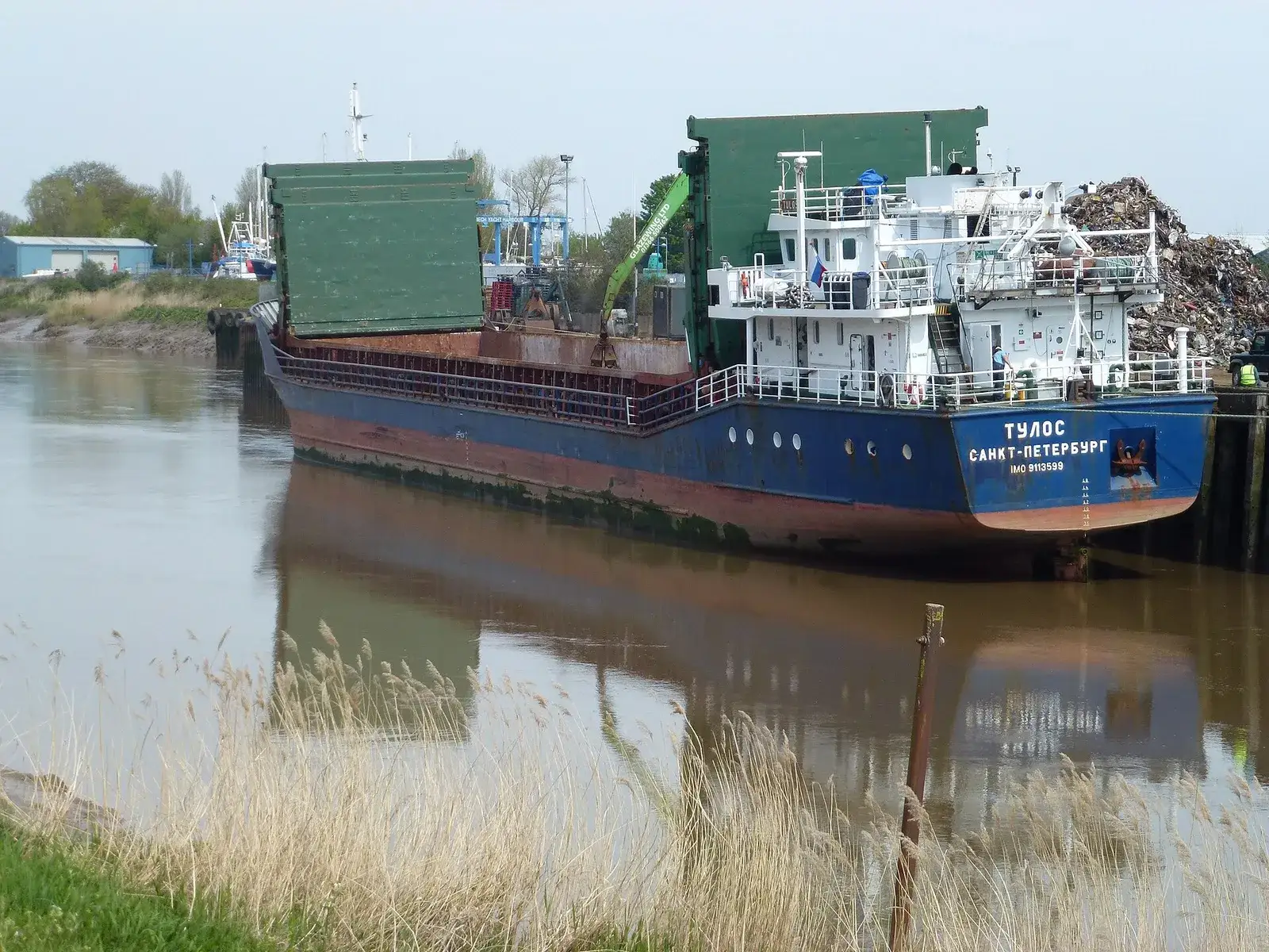 Coaster being loaded with ferrous scrap at a dock