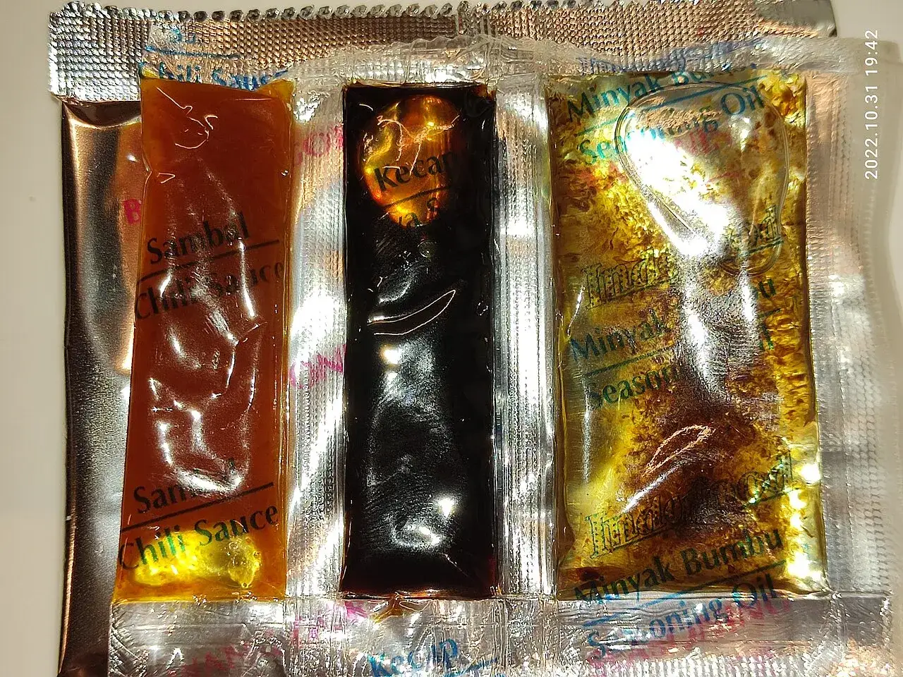 The seasoning sauce sachets supplied inside an Indomie Mi Goreng packet