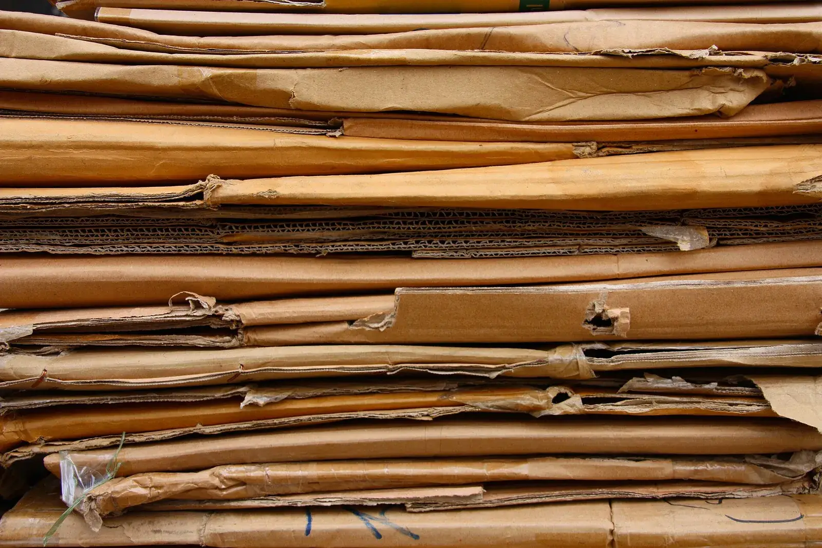 Stacked flattened brown cardboard for recycling