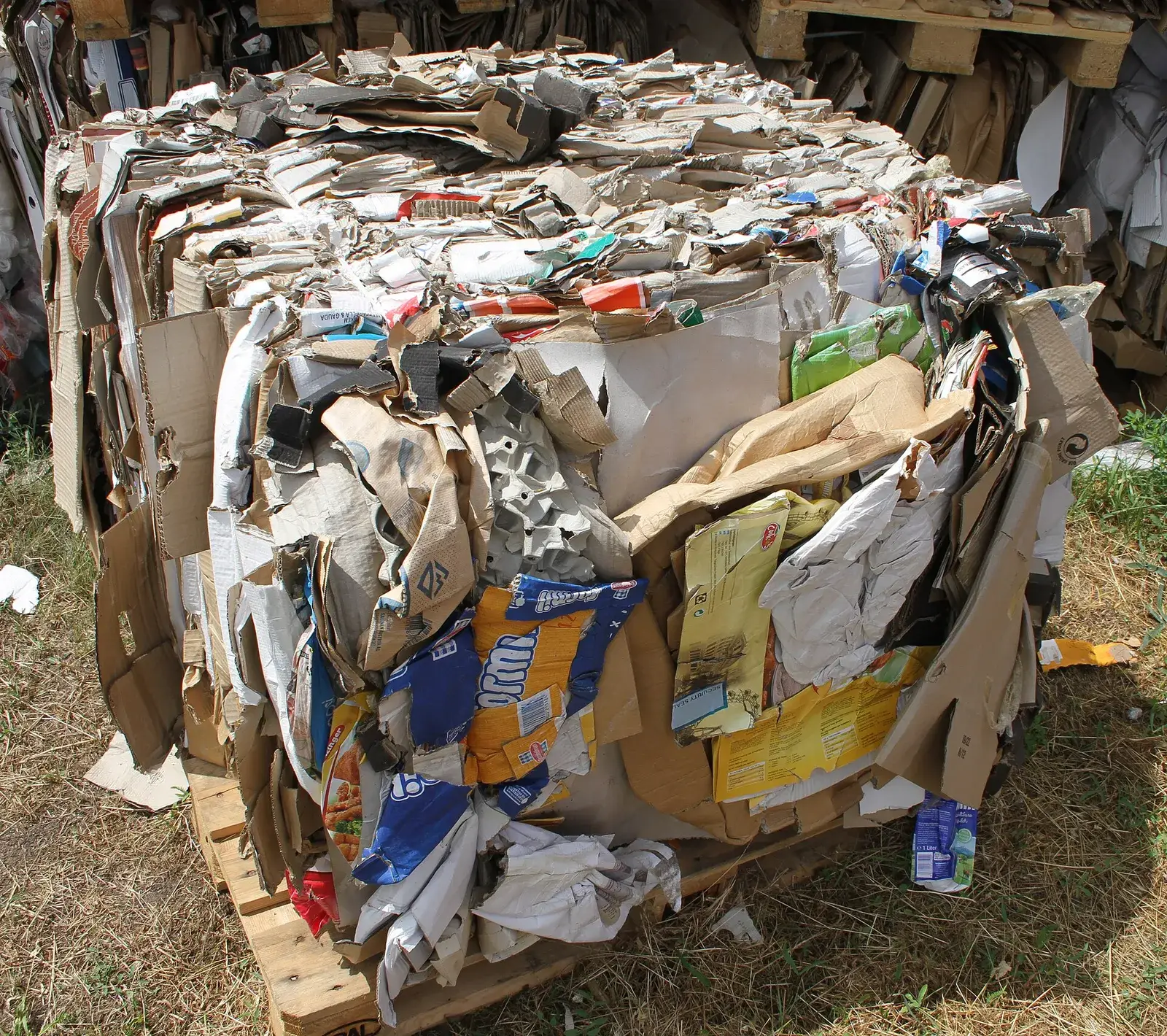 Pressed block of mixed waste paper and cardboard on a pallet