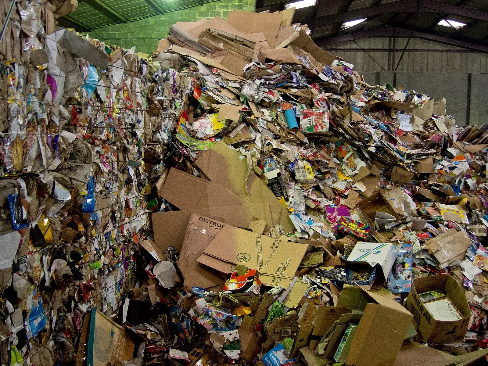 Heap of mixed paper and cardboard inside a recycling shed