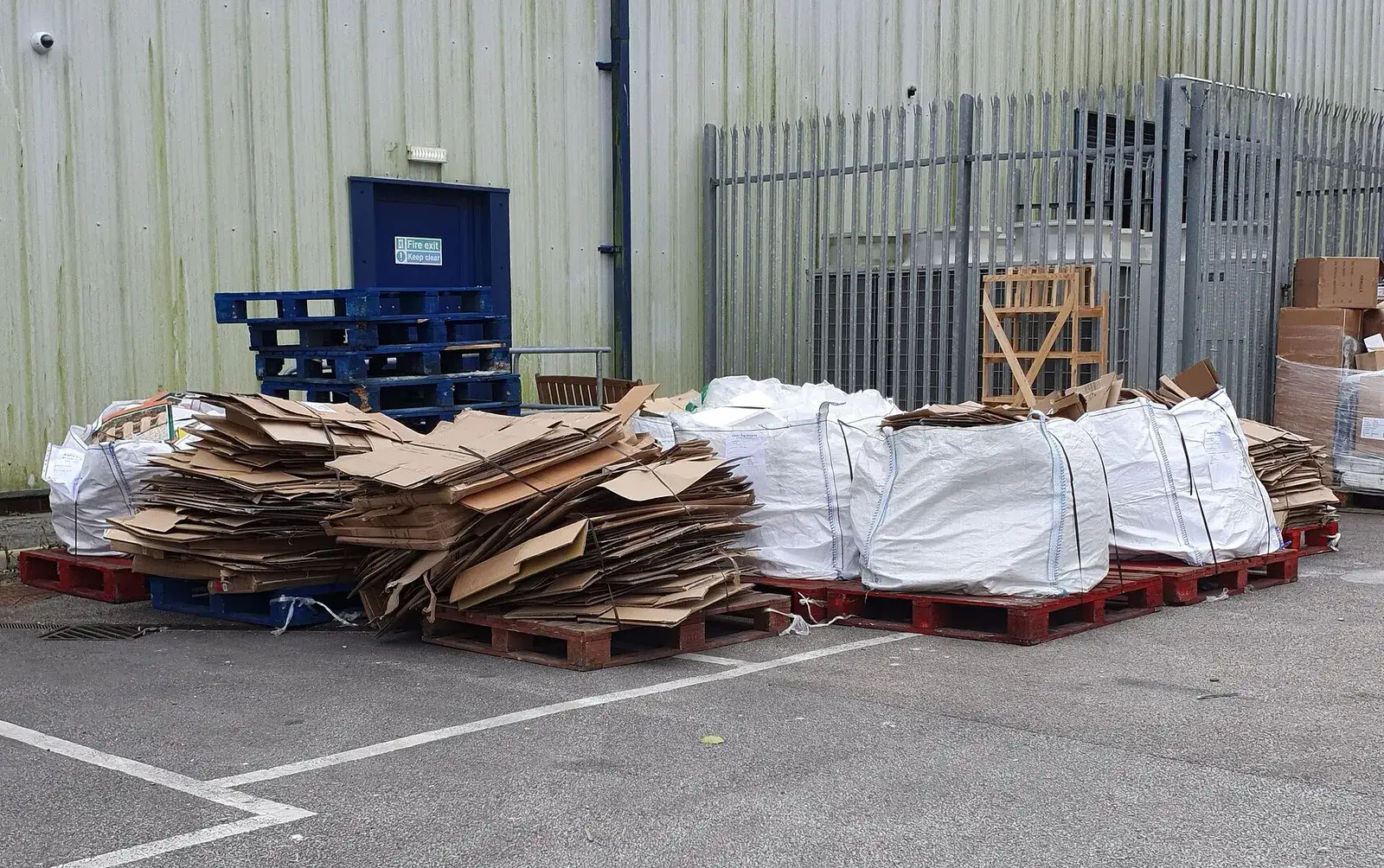 Flattened cardboard boxes stacked on pallets for recycling