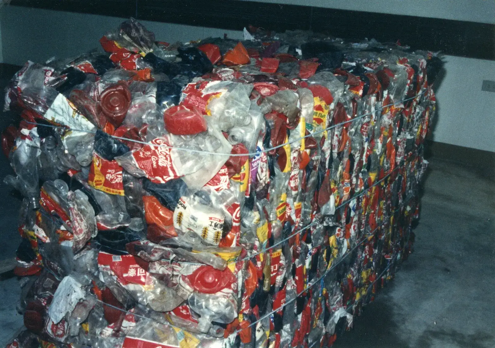 Compressed and strapped PET bottle bale inside a recycling plant