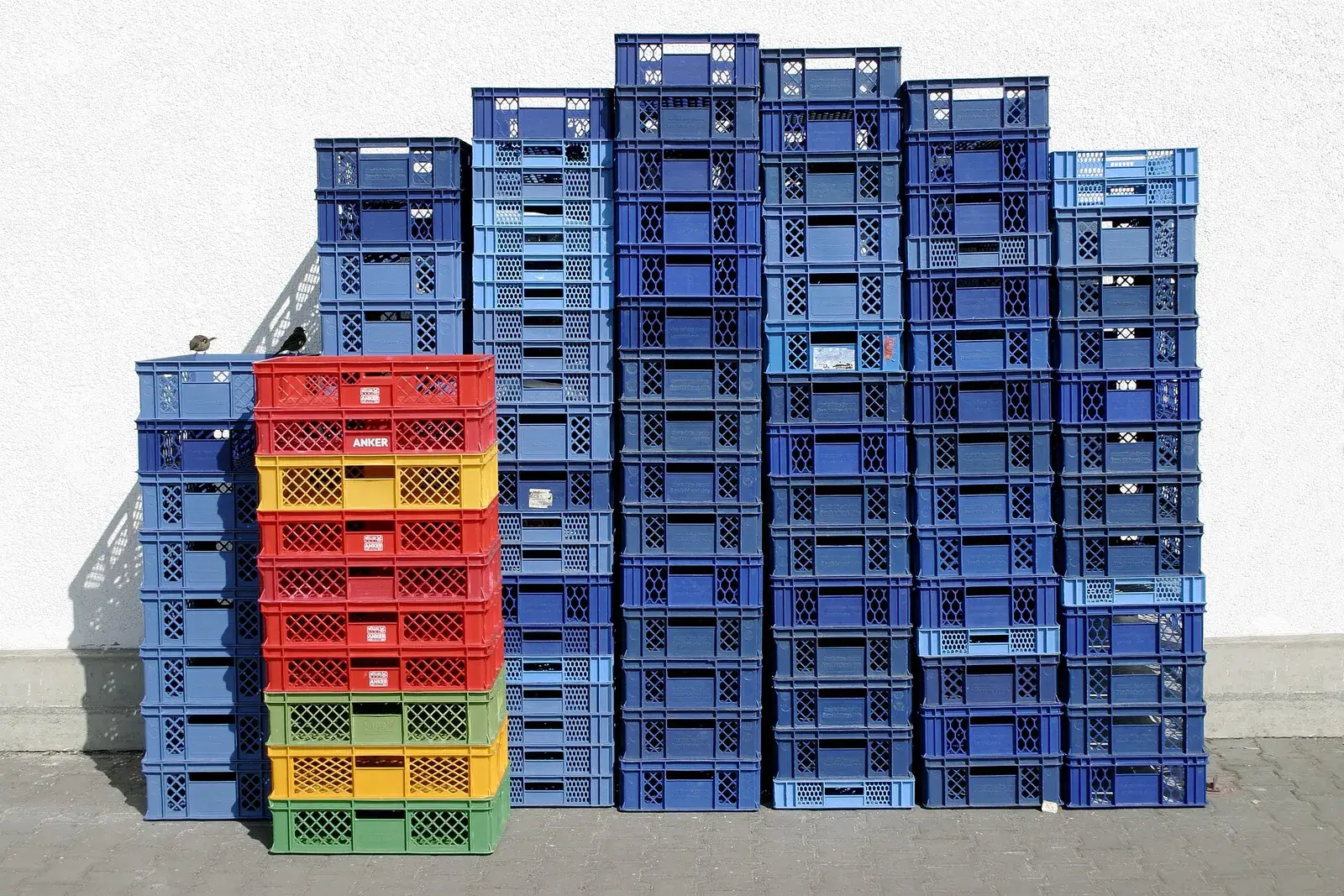 Stacks of plastic shipping crates at a recycling plant