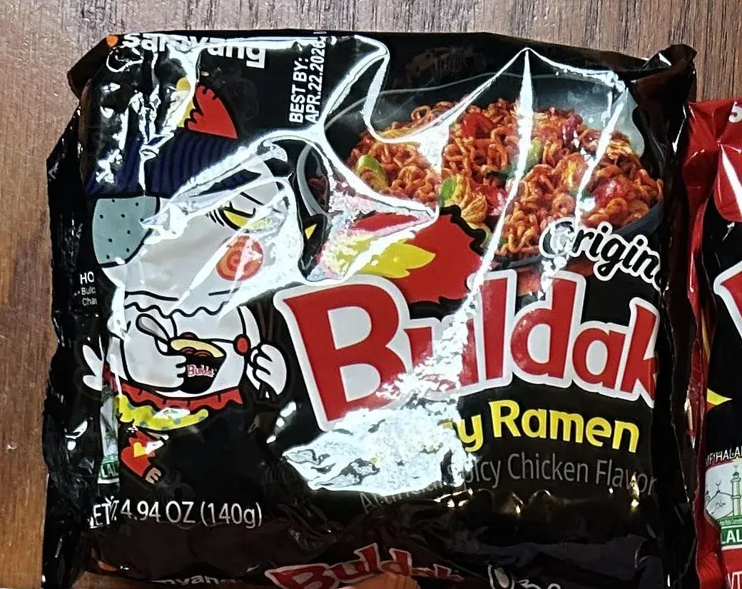 Front of a Samyang Buldak Original Spicy Ramen pack, net weight 4.94 oz (140 g)