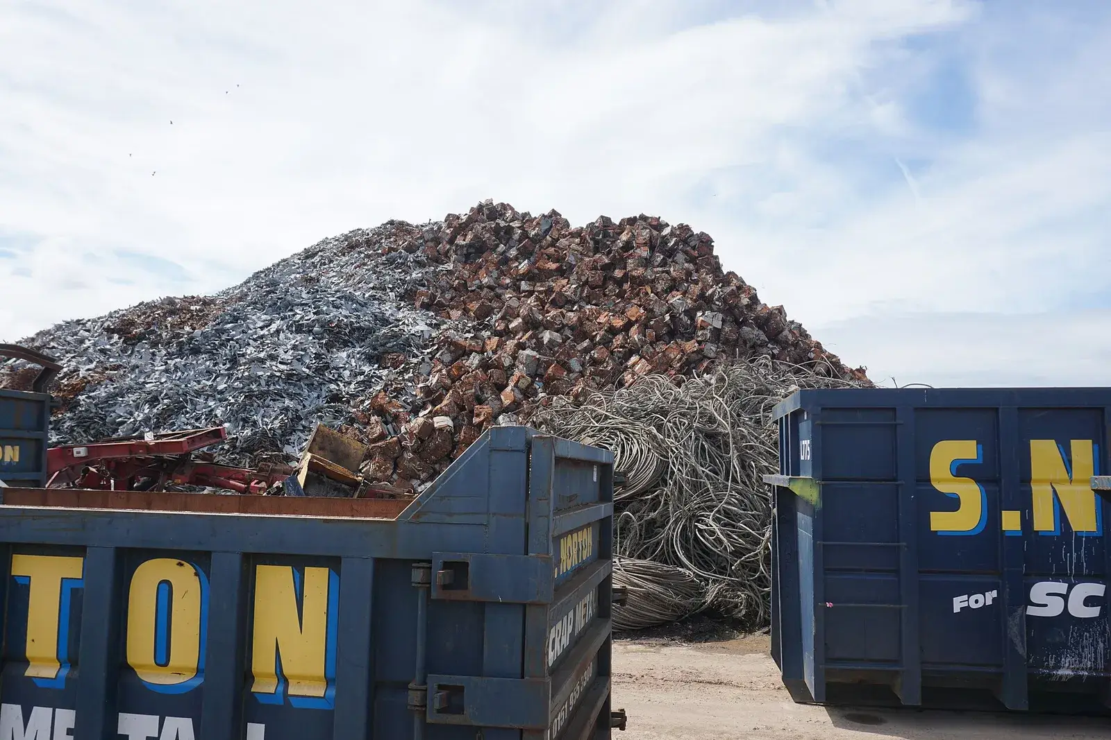 Large piles of processed ferrous scrap at a dock