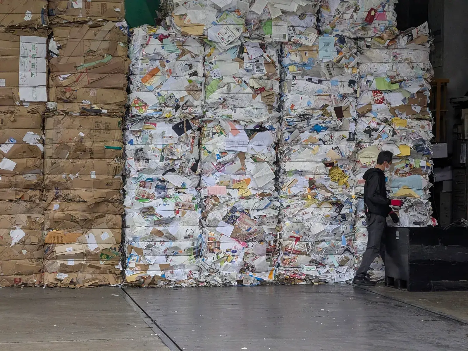 Compacted bales of used printed paper at a collection point