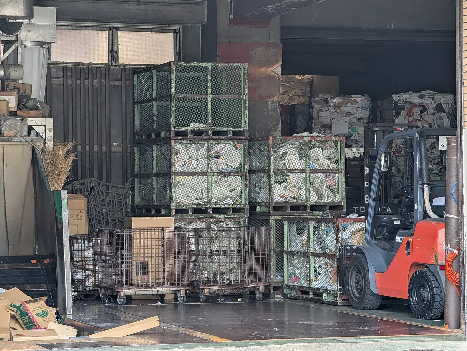 Paper recycling facility with baled paper and forklift