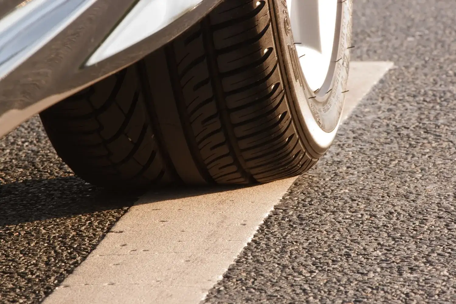 Summer car tyre fitted to a wheel, seen from the side