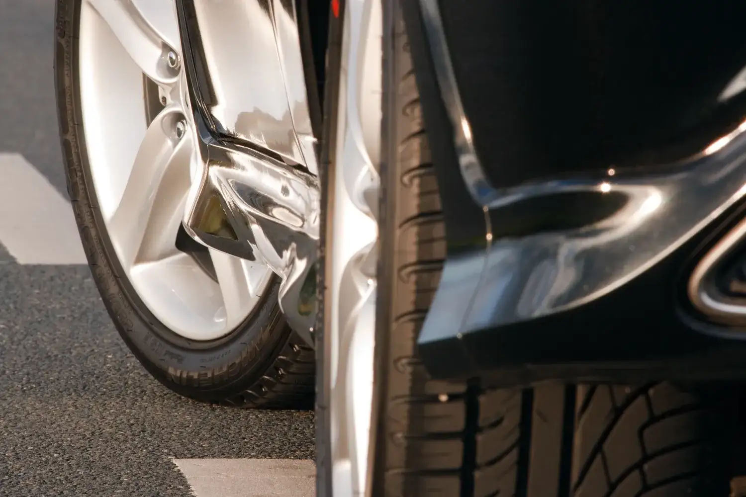 Summer car tyre on an alloy wheel under a wheel arch