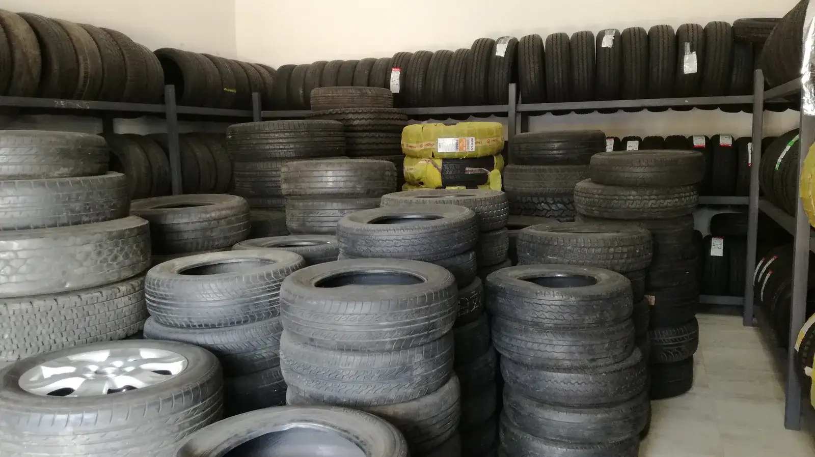 Tyres stacked on racks in a tyre shop