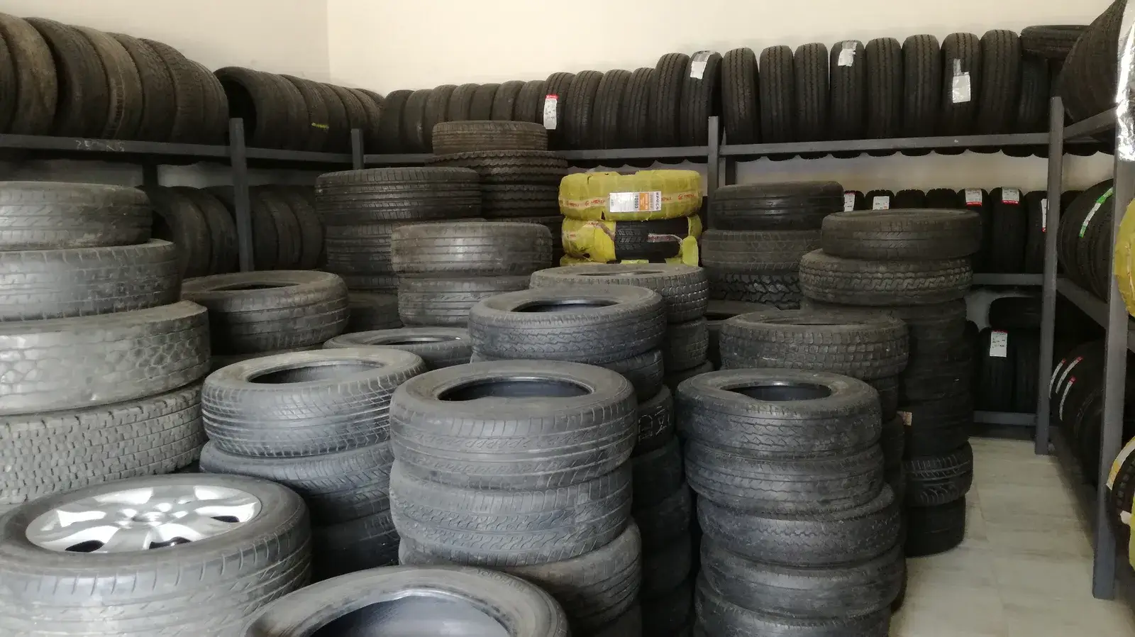 Tyres stacked on racks in a tyre shop